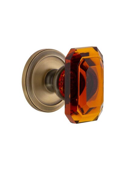 Grandeur Circulaire Rosette Door Set with Amber Crystal-Glass Baguette Knobs in Antique Brass.